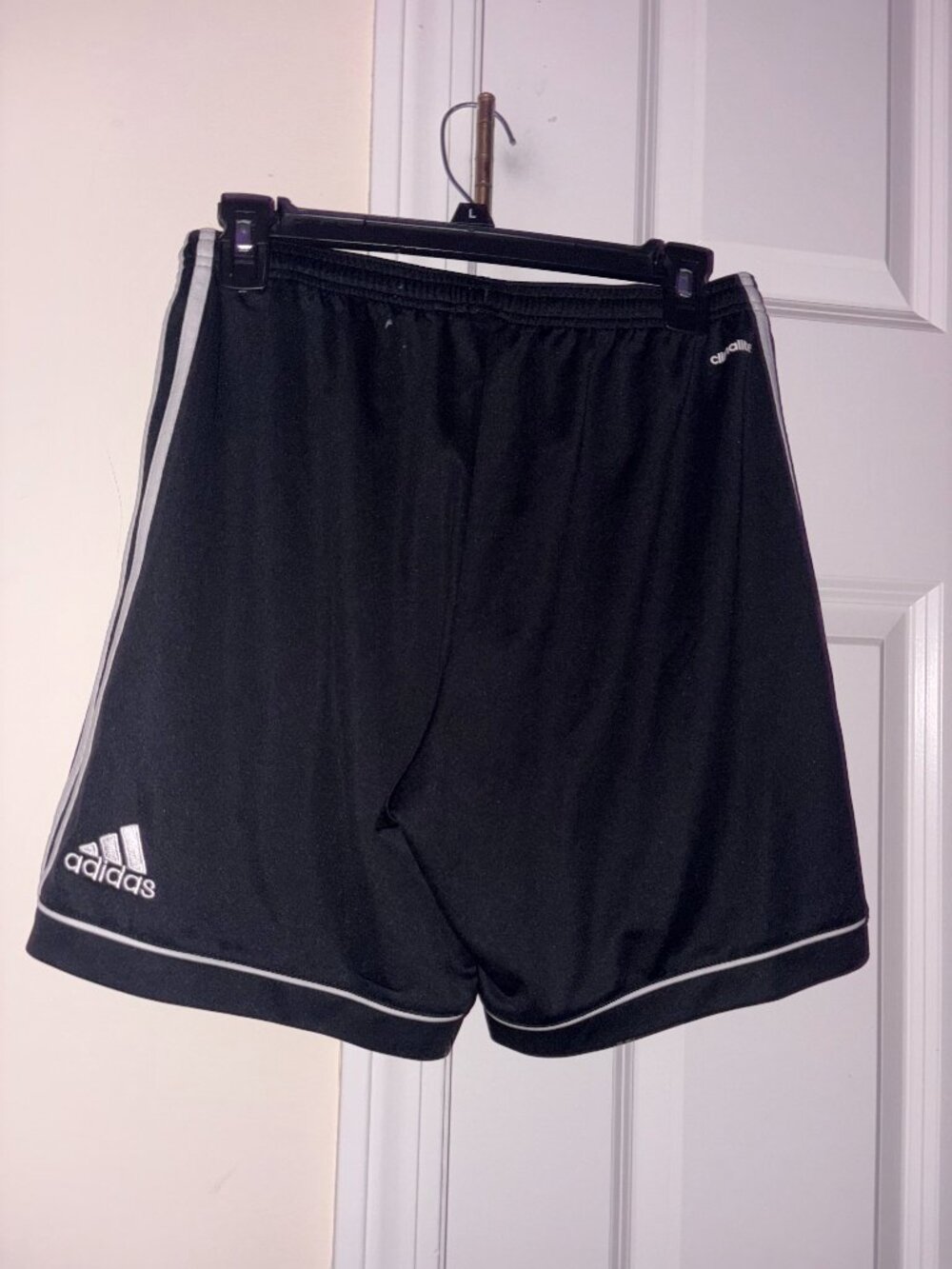 Adidas athletic soccer shorts, solid black with white accents, womens size M.